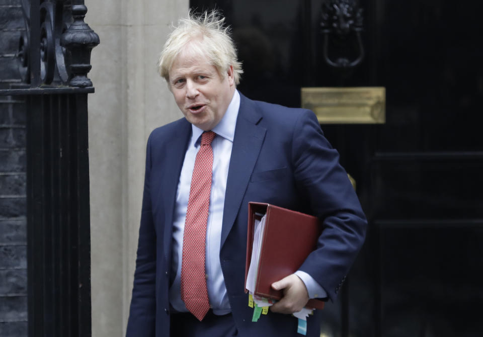 Britain's Prime Minister Boris Johnson leaves 10 Downing Street to attend the weekley session of Prime Ministers Questions in Parliament in London, Wednesday, Jan. 22, 2020. (AP Photo/Kirsty Wigglesworth)