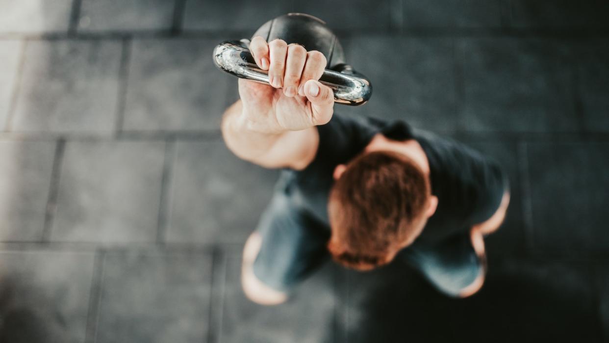  Aerial view of man performing kettlebell exercise 