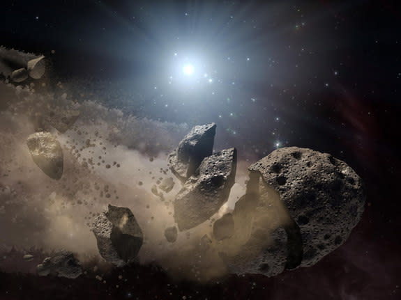 An artist’s illustration of an asteroid breaking apart in space.