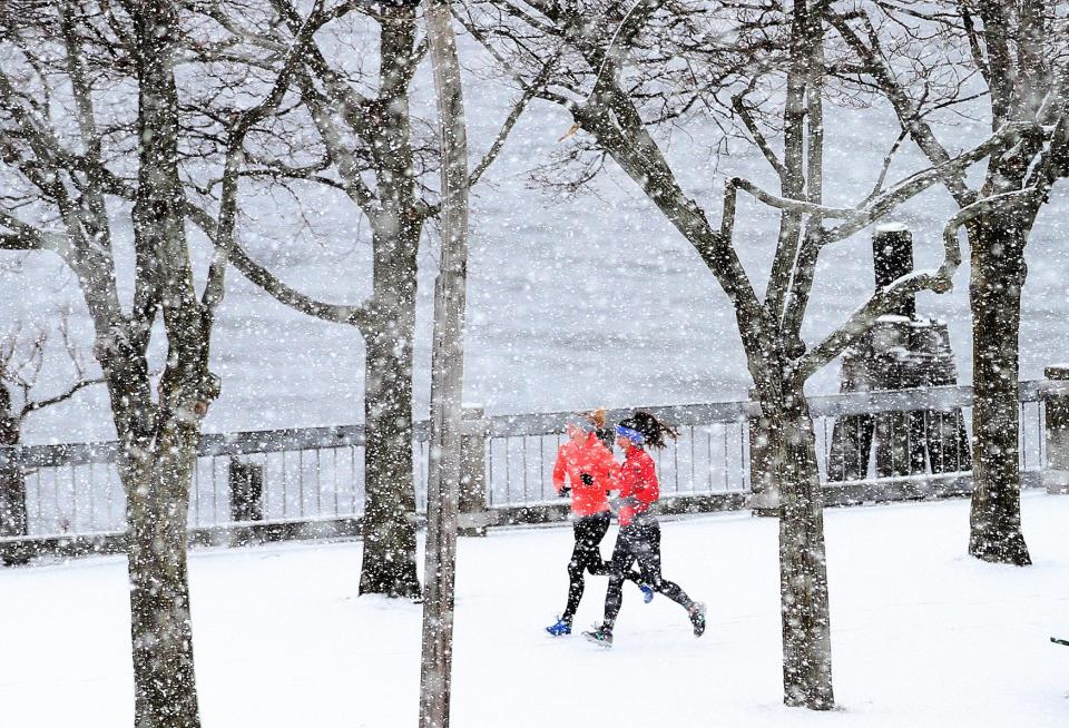 Runners revel in new-fallen snow on New Years Day 2017 in Providence's India Point Park.  [Glenn Osmundson/Providence Journal, file]