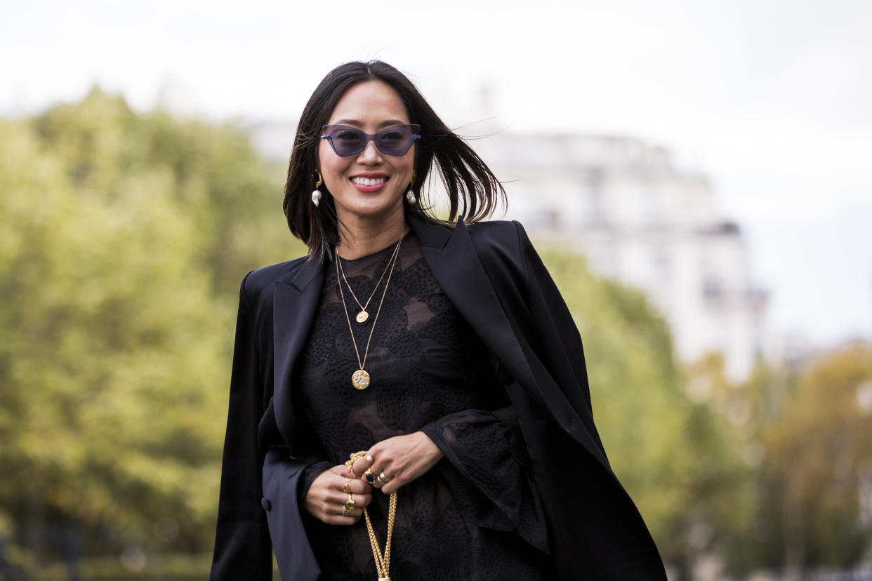 PARIS, FRANCE - SEPTEMBER 30:  Aimee Song, wearing a black lace mini dress, black blazer, black printed boots, and blue mini bag, is seen before the Valentino show on September 30, 2018 in Paris, France. (Photo by Claudio Lavenia/Getty Images)