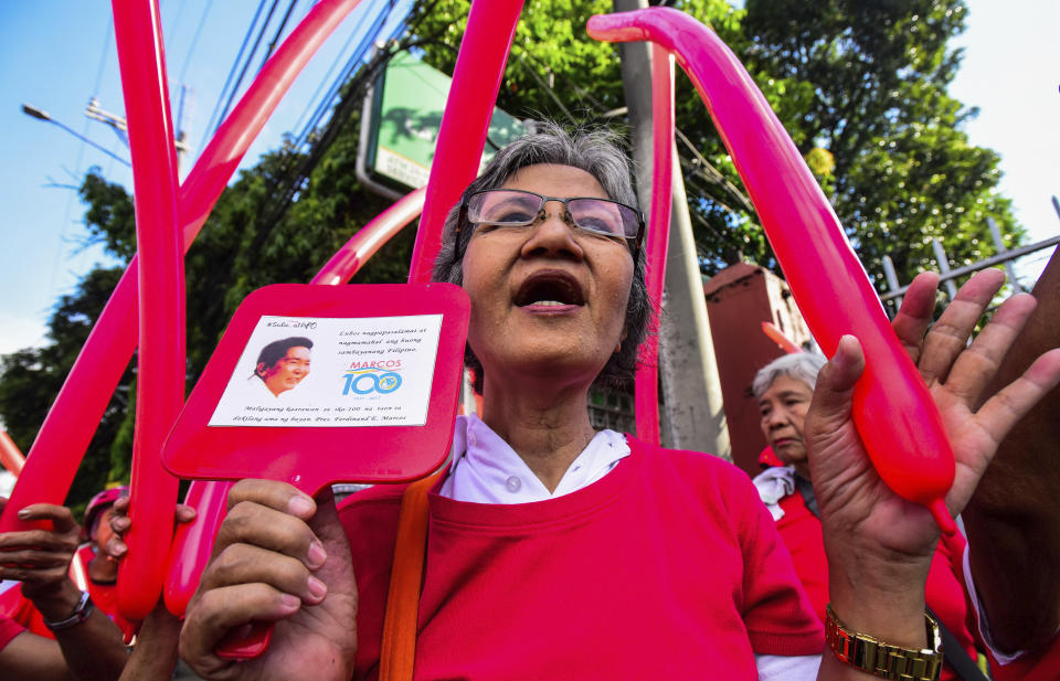Supporters of former Philippine First Lady Imelda Marcos gather outside the anti-graft court Sandiganbayan to await her arrival following the Court's order for her to appear to explain her side for not attending last week's promulgation of the graft charges against her Friday, Nov. 16, 2018 in suburban Quezon city northeast of Manila, Philippines. A Philippine court found Imelda Marcos guilty of graft and ordered her arrest last week in a rare conviction among many corruption cases that she's likely to appeal to avoid jail and losing her seat in Congress. (AP Photo/Maria S. Tan)