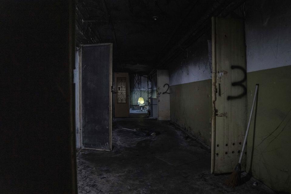 FILE - An office chair stands in the corridor of a basement in a building used, according to a war crimes prosecutor, by Russian forces as a place of torture in Kherson, Ukraine, Dec. 8, 2022. In a deliberate, widespread campaign, Russian forces systematically targeted influential Ukrainians, nationally and locally, to neutralize resistance through detention, torture and executions, an Associated Press investigation has found. (AP Photo/Evgeniy Maloletka, File)