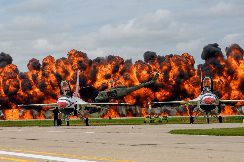 US Air Force Thunderbirds sit on the tarmac while a helicopter picks up a downed pilot amid pyrotechnics simulation during a Vietnam War reenactment at the Sioux Falls Airshow in South Dakota in August 2019.