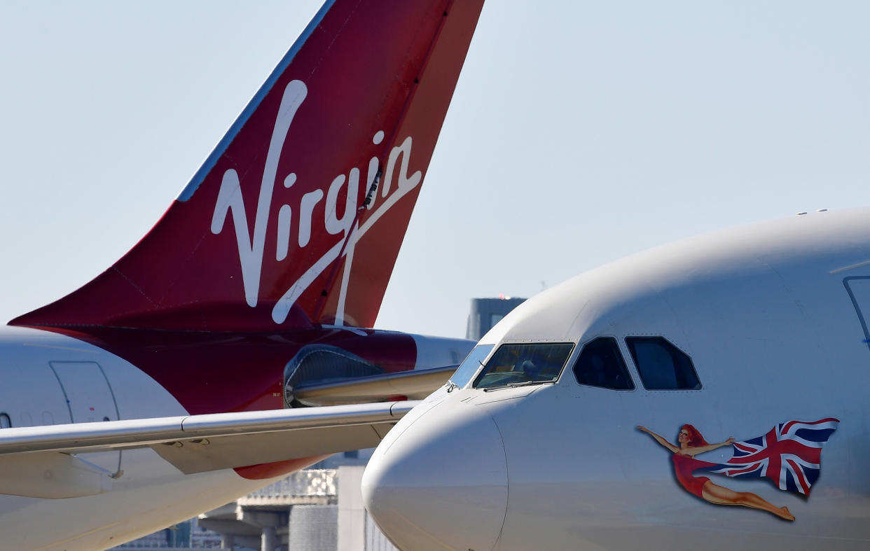 A Virgin Atlantic aeroplane tailfin and nose livery are seen at Heathrow airport.