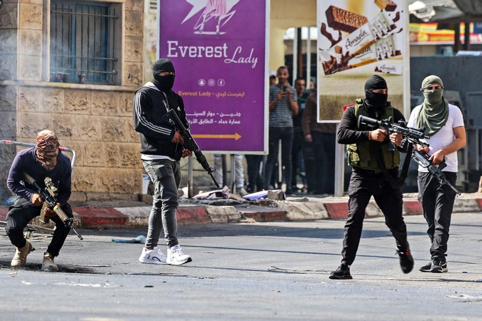 Palestinian armed militants take up position during a confrontation with Israeli army in the occupied West Bank city of Jenin on July 3, 2023.