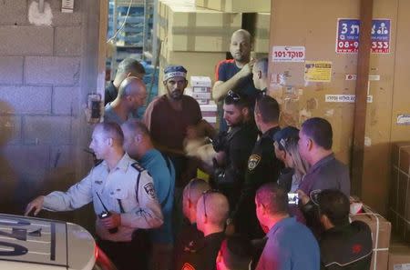 Police apprehend a suspected attacker at the scene of a Palestinian stabbing attack in Tel Aviv, Israel November 19, 2015. REUTERS/Nir Elias TPX IMAGES OF THE DAY