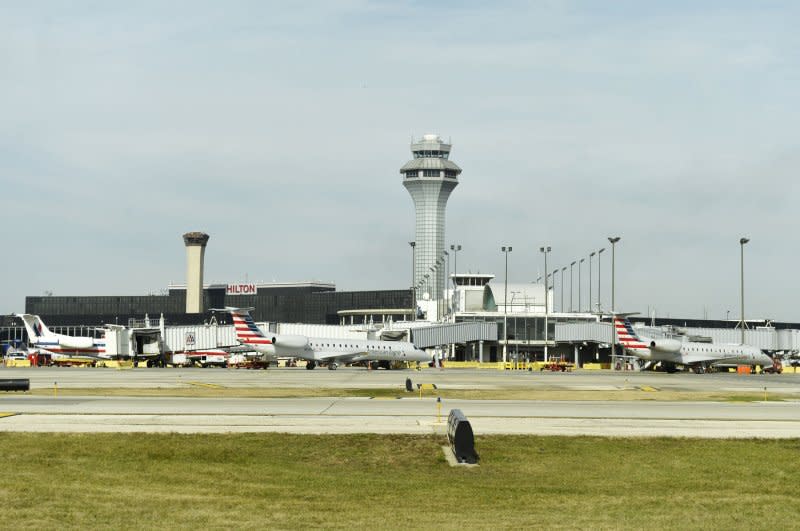 Planes wait at gates as the main control tower rises above the terminals in the center of O'Hare International Airport on November 5, 2014, in Chicago. On August 3, 1981, U.S. air traffic controllers went on strike. The strikers were fired within one week. File Photo by Brian Kersey/UPI