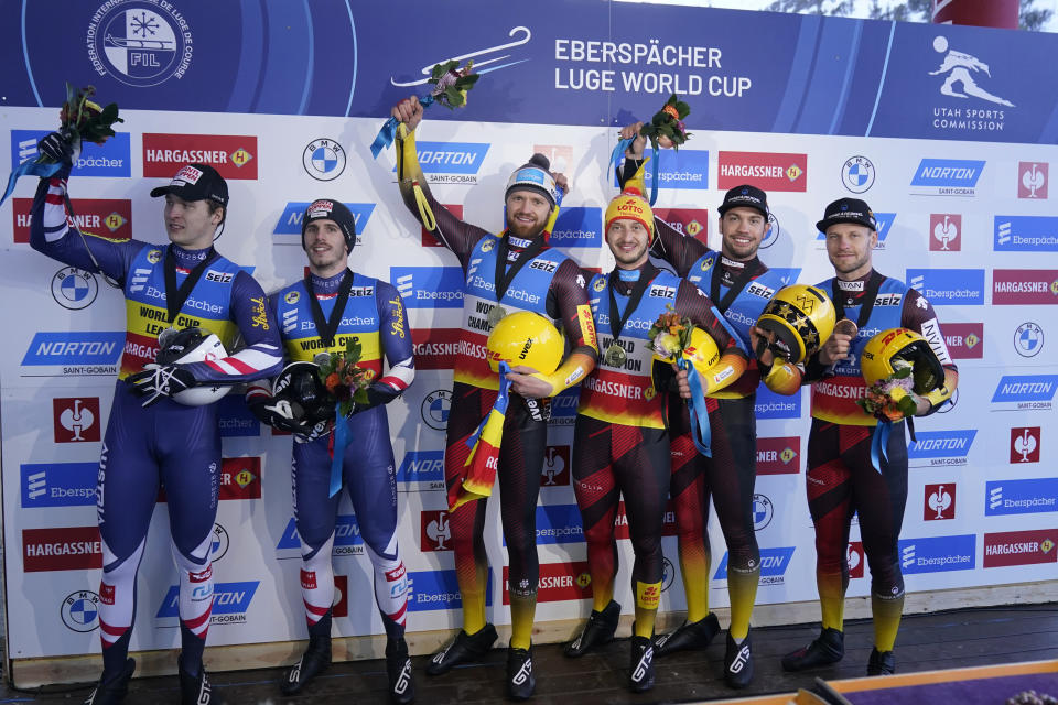 First-place finishers Germany's Toni Eggert and Sascha Benecken, center, share the podium with second-place finishers Austria's Juri Thomas Gatt and Riccardo Martin Schopf, left, and third-place finishers Germany's Tobias Wendl and Tobias Arlt, right, following the men's double at a World Cup luge event Friday, Dec. 16, 2022, in Park City, Utah. (AP Photo/Rick Bowmer)