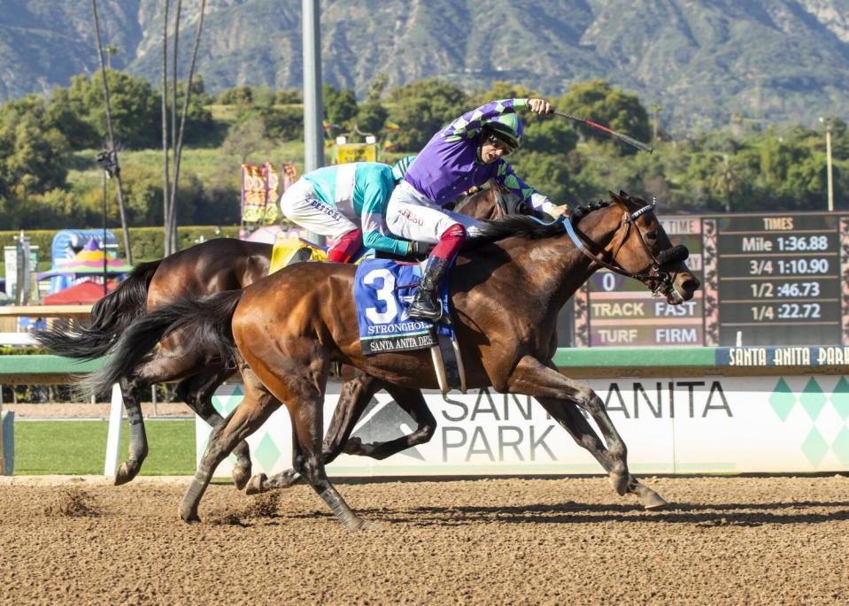 Stronghold, with jockey Antonio Fresu, overtake Imagination, with jockey lanfanco Dettori, to win the 2024 Santa Anita Derby.