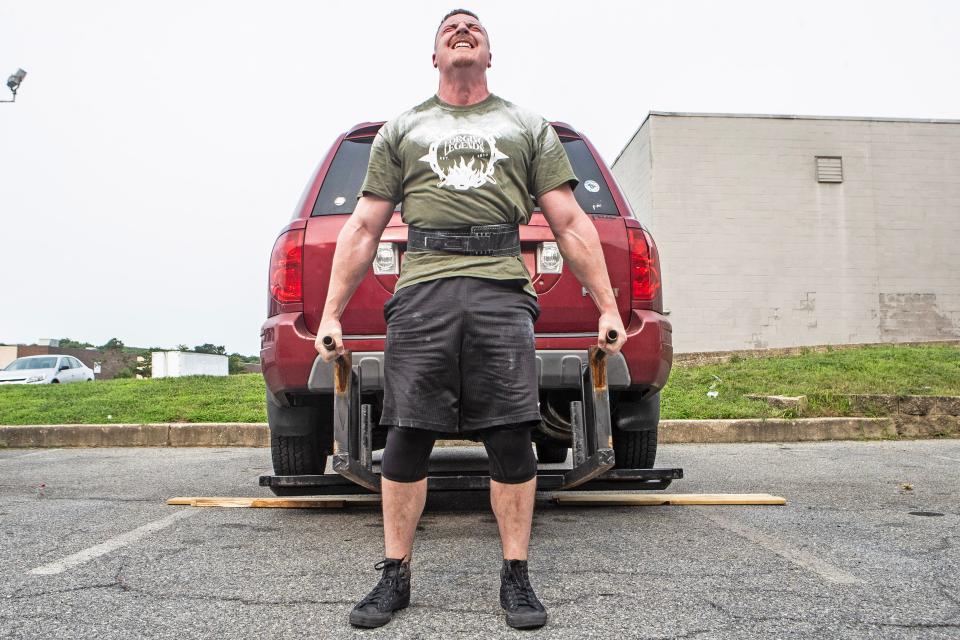 Bradie Crandall performs a car deadlift with a Honda Pilot at the Training Center near New Castle on Thursday, Aug. 3, 2023. Crandall, a chemical engineering doctoral candidate at the University of Delaware, is among the nation's top powerlifters and a vegan.