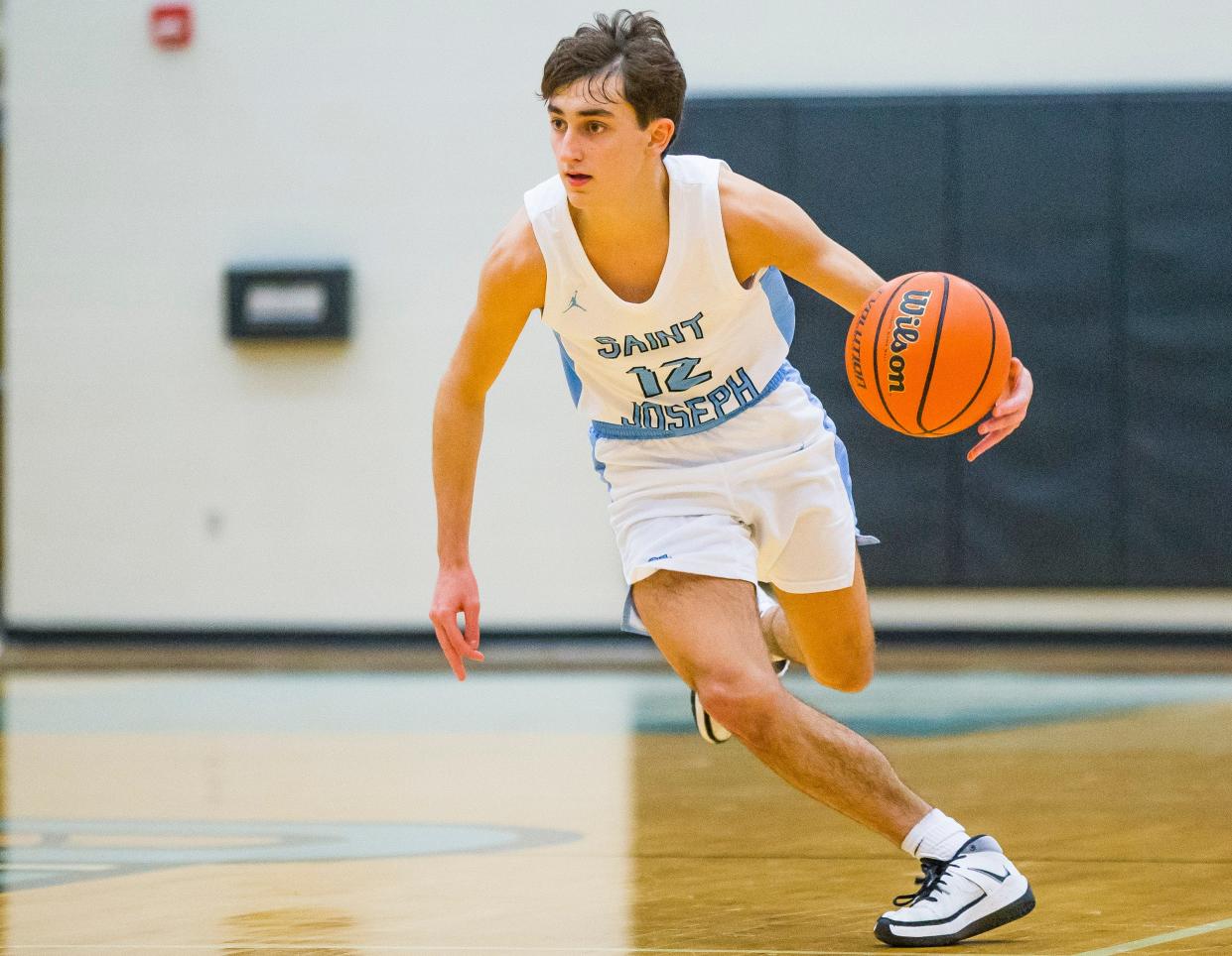 Saint Joseph’s Cole Hatkevich (12) drives to the basket during the Clay at Saint Joseph boys basketball game Thursday, Feb. 4. Hatkevich scored 17 points in Saint Joseph's win over South Bend Adams Friday night.