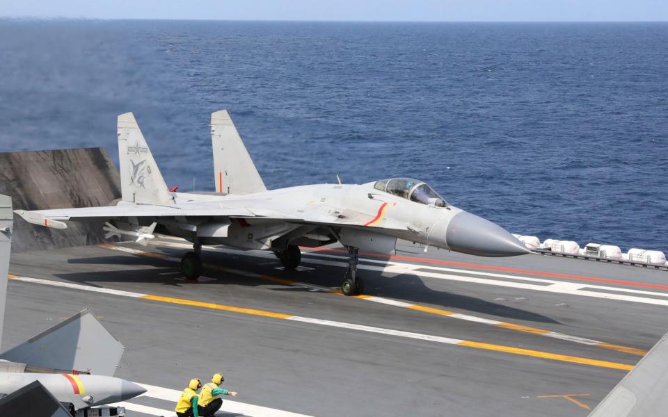 A Chinese J-15 carrier jet ready for takeoff at sea - An Ni/Xinhua