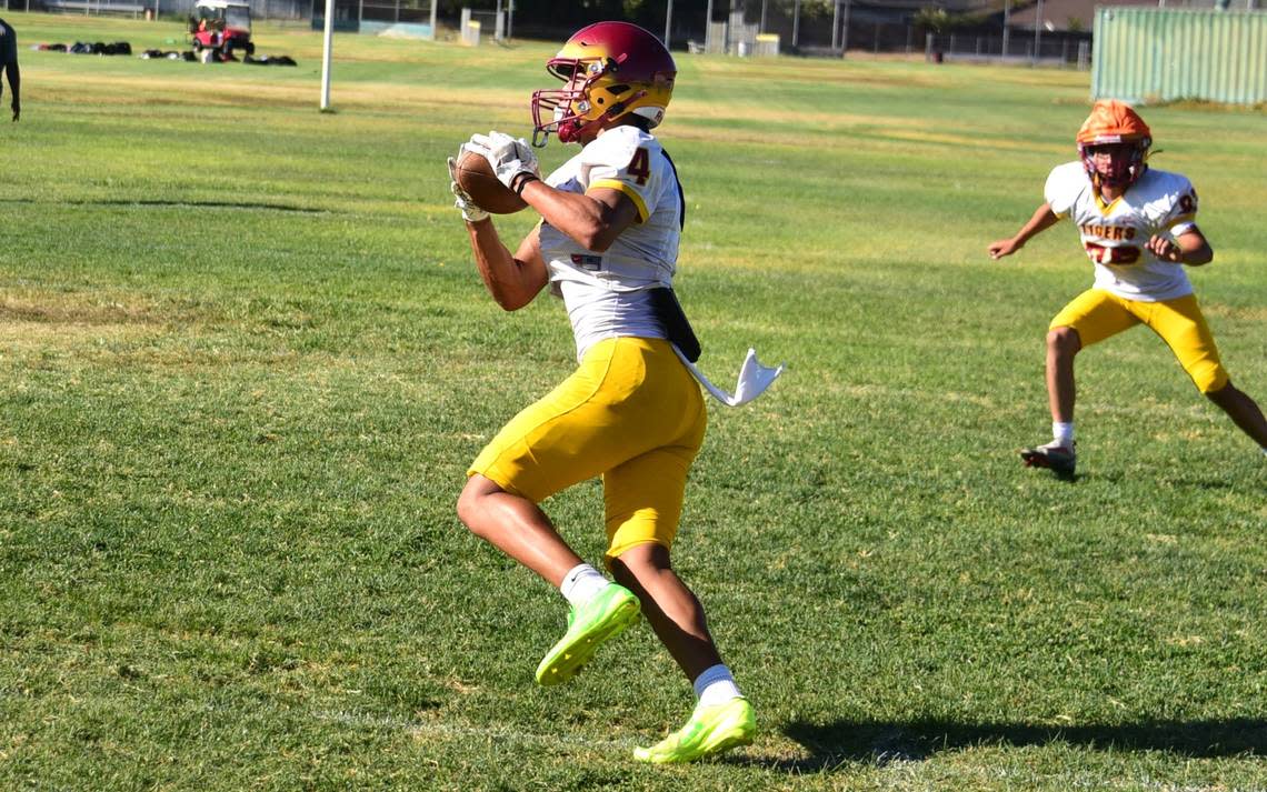 Los Banos High receiver Jahir Zuniga hauls on a pass during practice on Tuesday, Aug. 13, 2024.