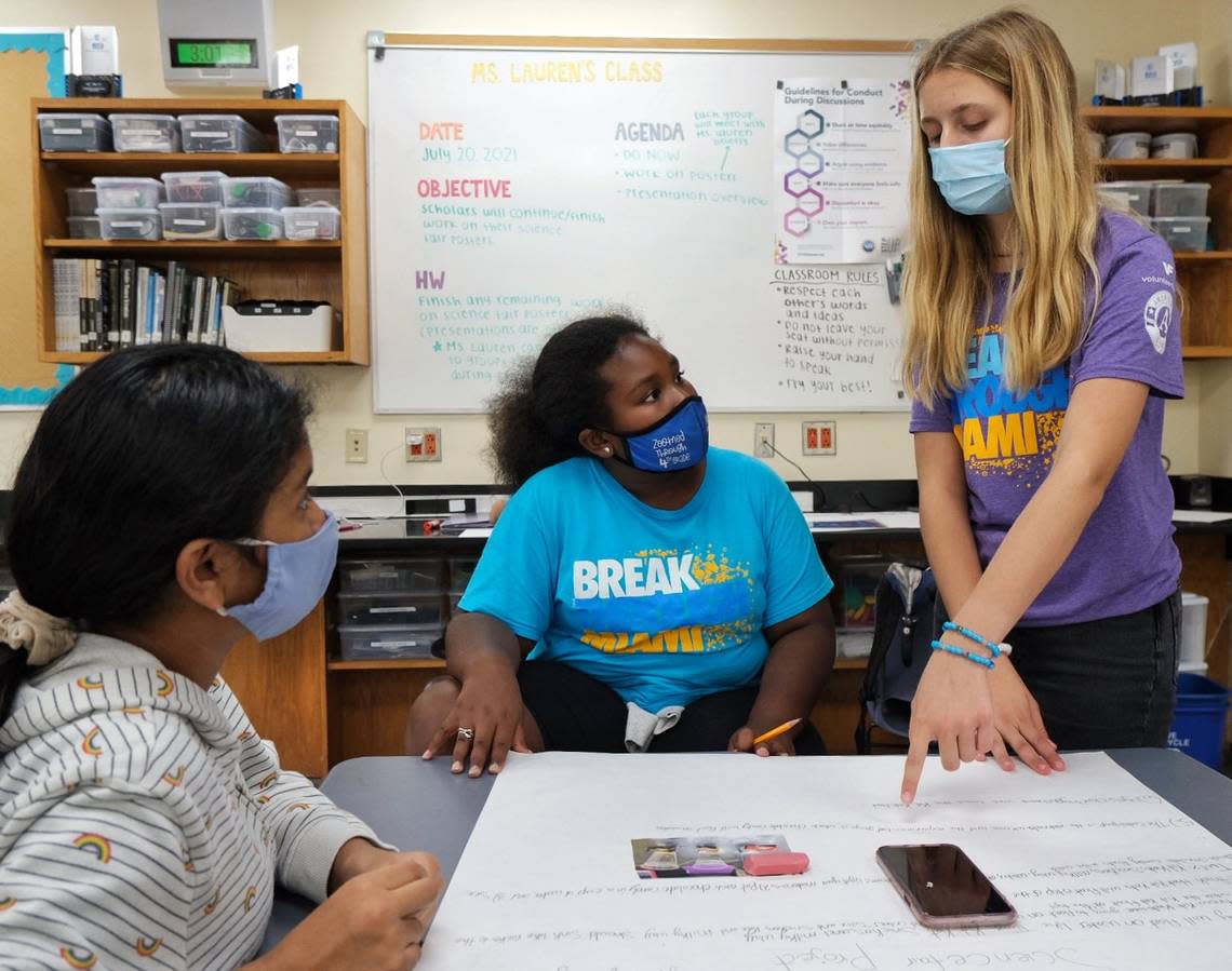 Breakthrough Miami teaching fellow Lauren Zanarini, a senior at Ransom Everglades School in Coconut Grove, instructs fifth grade Breakthrough Scholars Abigail Morales and Kaleigh Burse as they work on a science project in July 2021 to demonstrate their understanding of the scientific method.