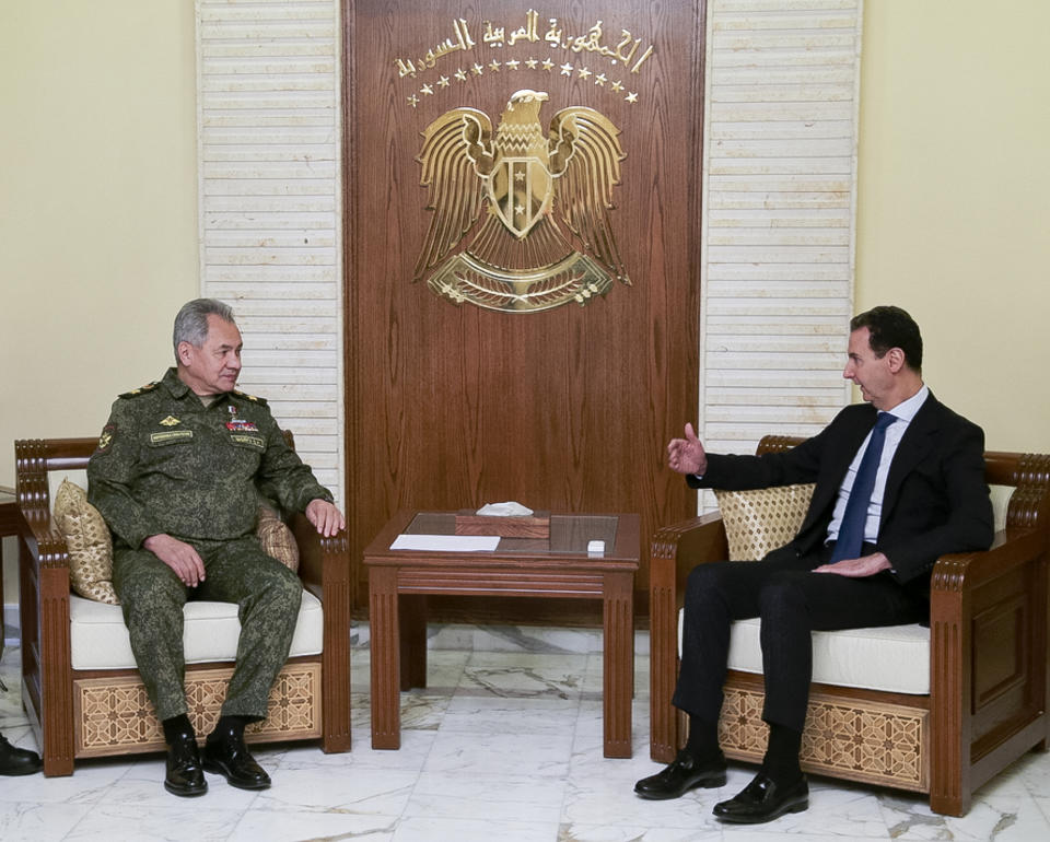 FILE - In this image from video provided by the Russian Defense Ministry Press Service on Feb. 15, 2022, Russian Russian Defense Minister Sergei Shoigu, left, listens to Syrian President Bashar Assad during their talks in Damascus, Syria. (Russian Defense Ministry Press Service via AP, File)