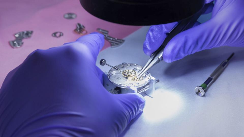 In this photo provided by Kansas City National Security Campus, an employee works on a mechanical wristwatch at the National Nuclear Security Administration's Kansas City facility in Kansas City, Mo., May 23, 2023. (Kansas City National Security Campus via AP)