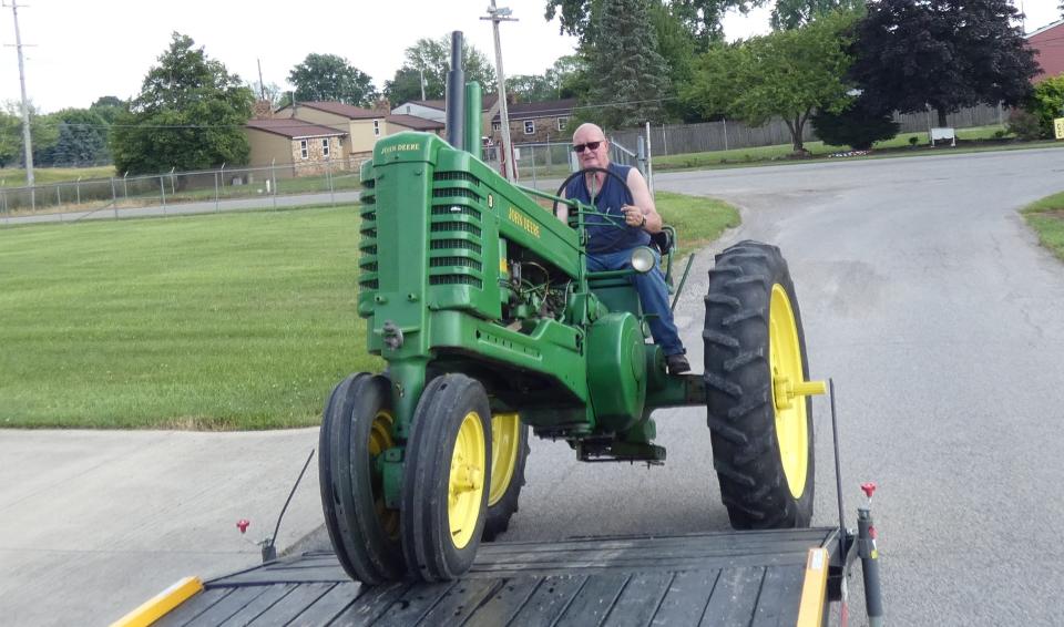 Roger Haas unloads his 1951 John Deere B tractor outside the Crawford Museum of Agriculture at the Crawford County Fairgrounds on Monday in preparation for Crawford Antique Farm Machinery's 22nd annual show, which runs Thursday through Saturday.