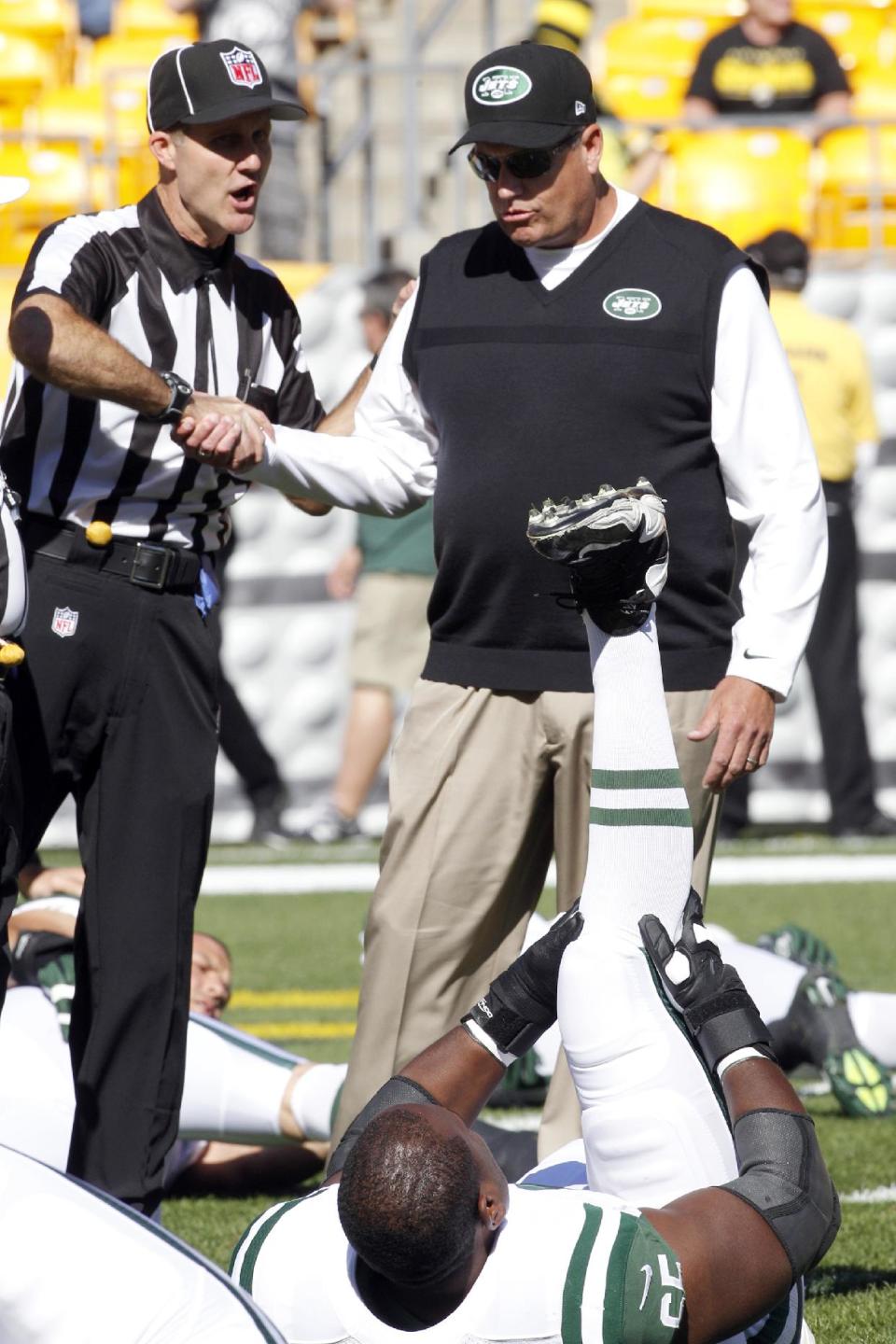 New York Jets head coach Rex Ryan, top right, shakes hands with an official as his team warms up before an NFL football game against the Pittsburgh Steelers in Pittsburgh, Sunday, Sept. 16, 2012. (AP Photo/Keith Srakocic)