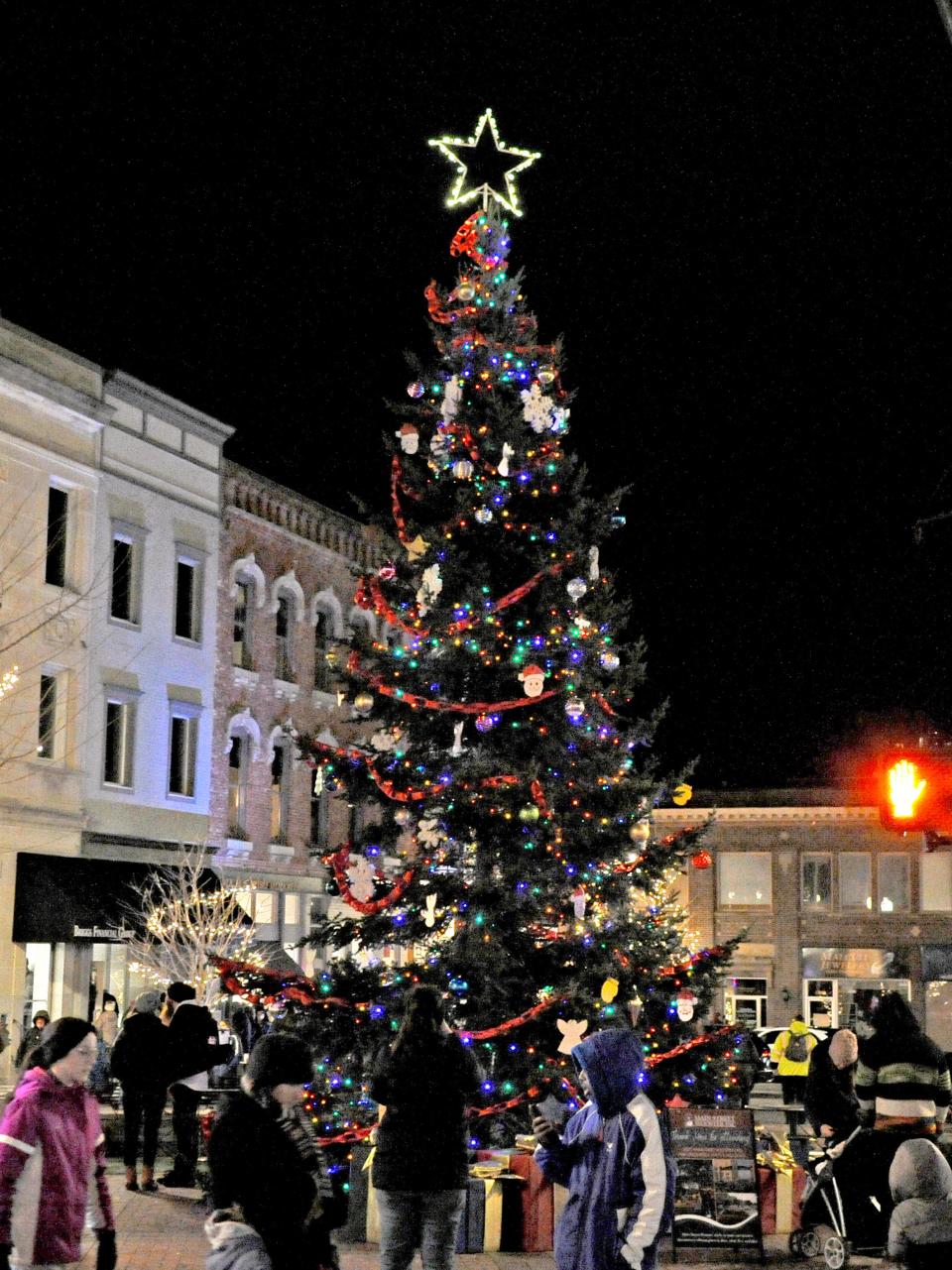 The Christmas tree stands tall and bright in downtown Wooster shortly after the lights were turned on Friday evening during the annual Window Wonderland event.