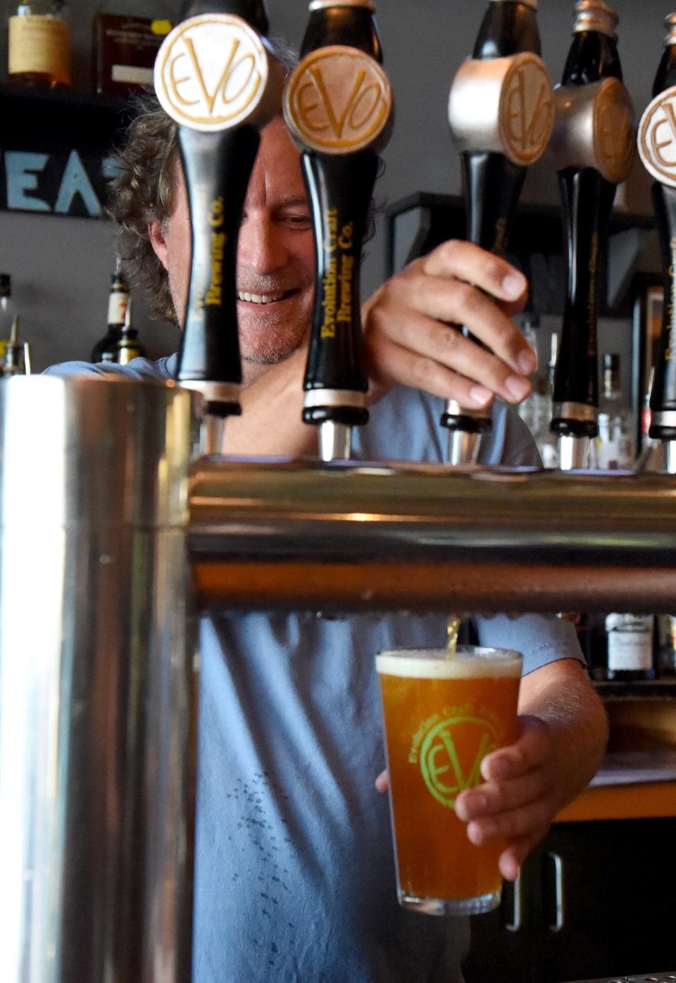 Tom Knorr, co-founder of Evolution Craft Brewing Company, pours a beer in the Tasting Room and Brewery Friday, Aug. 27, 2021, in Salisbury, Maryland.