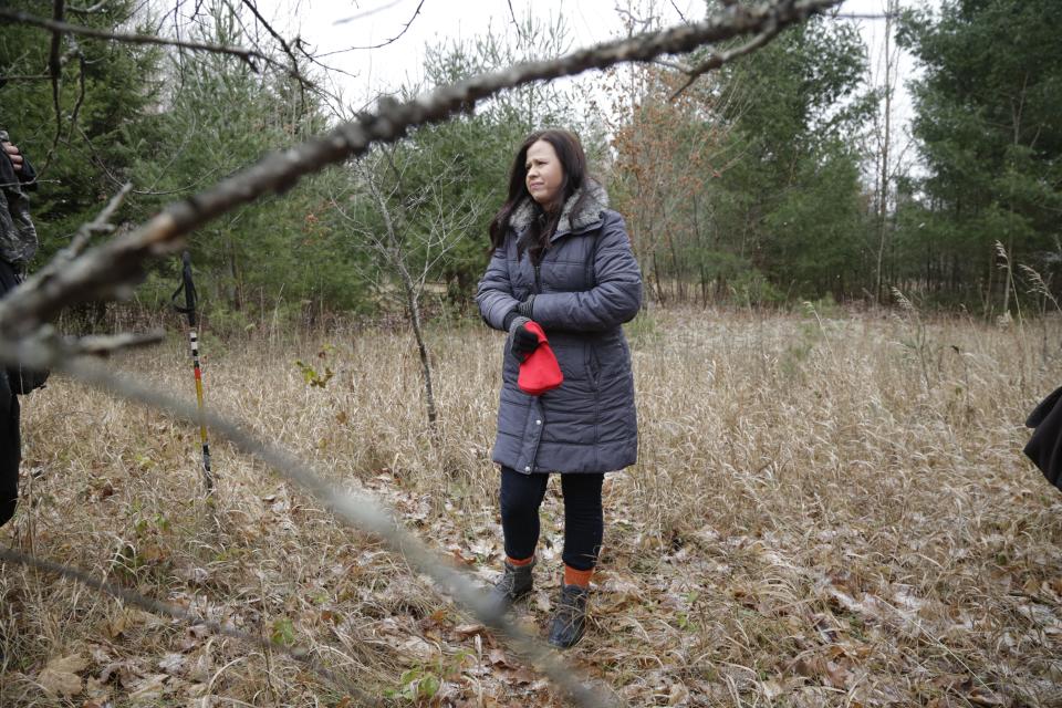 Meghan Moeggenborg, the daughter of Michigan State trooper David Moeggenborg, searches the woods not far her now deceased father's home in fall of 2017.