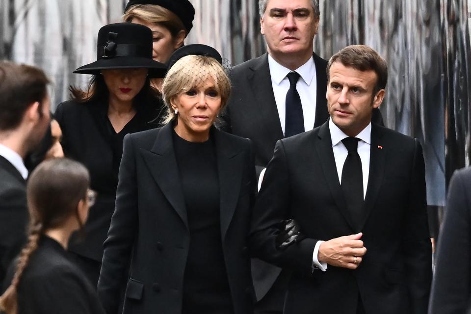 French President Emmanuel Macron (R) and his wife Brigitte Macron arrive at Westminster Abbey in London on Sept. 19, 2022, for Queen Elizabeth II's funeral.