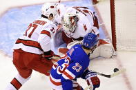 Carolina Hurricanes' goaltender James Reimer (47) looks for the puck as Hurricanes' Andrei Svechnikov (37) and New York Rangers' Adam Fox (23) chase during second period NHL Eastern Conference Stanley Cup playoff action in Toronto on Tuesday, Aug. 4, 2020. (Frank Gunn/The Canadian Press via AP)