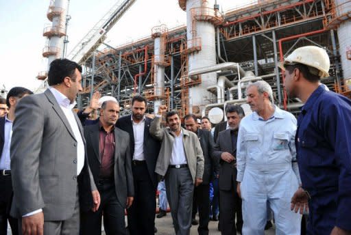 Iranian President Mahmoud Ahmadinejad (C) tours the Abadan oil refinery during the inauguration of a petrol making unit in the southwestern city of Abadan in 2011. A European Union embargo on Iranian oil went into effect on Sunday, provoking anger in Tehran which says the measure will hurt talks with world powers over its sensitive nuclear activities