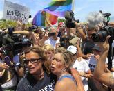 U.S. long-distance swimmer Diana Nyad (front R), 64, is welcomed ashore after completing her swim from Cuba as she arrives in Key West, Florida, September 2, 2013. REUTERS/Andrew Innerarity