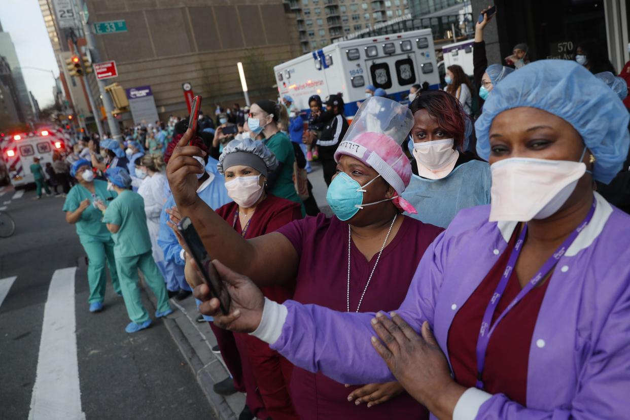 Medical personnel attend a nightly 7pm applause in their honor on Tuesday, April 28, 2020, outside NYU Langone Medical Center in the Manhattan borough of New York.