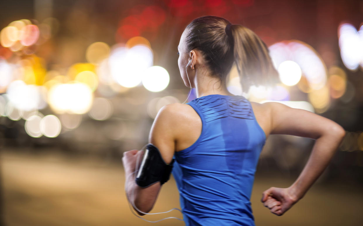 Young woman jogging at night in the city