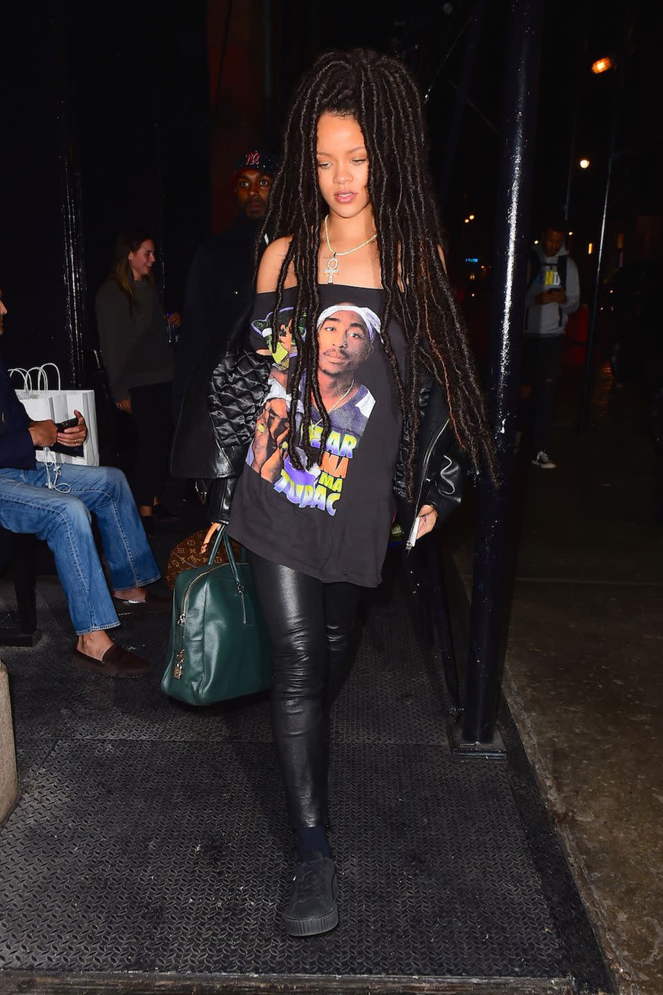 <p>In a leather jacket, off-the-shoulder Tupac t-shirt, leather leggings, black Fenty x Puma creepers, Louis Vuitton box bag, green leather tote and Moschino phone case in NYC.</p>