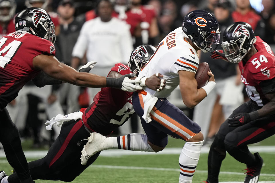 Chicago Bears quarterback Justin Fields (1) runs against the Chicago Bears during the first half of an NFL football game, Sunday, Nov. 20, 2022, in Atlanta. (AP Photo/Brynn Anderson)