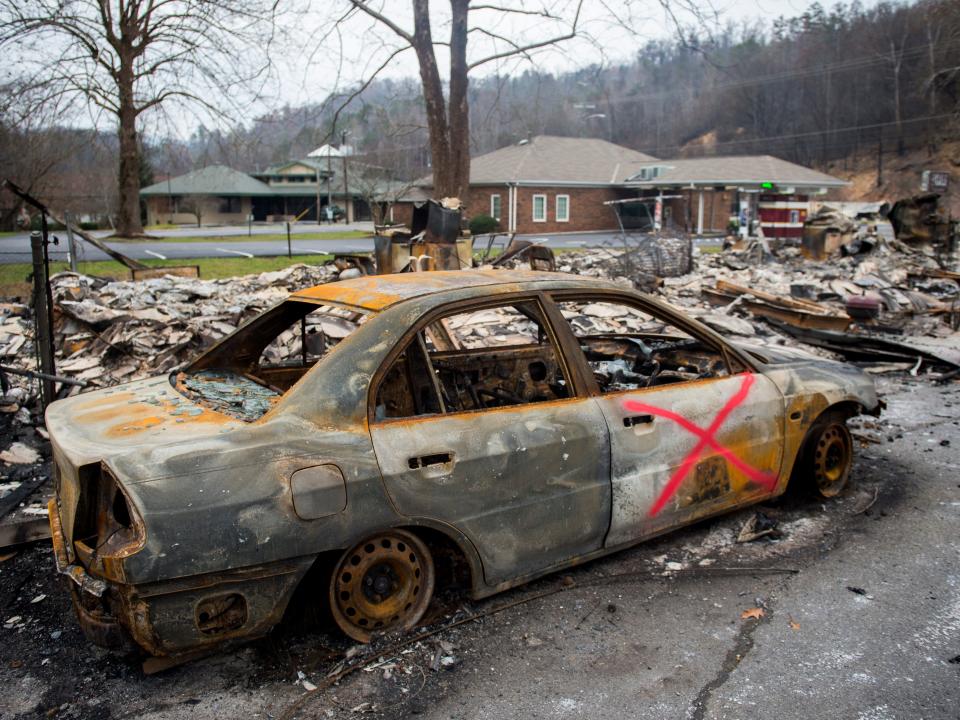 A destroyed car sits among the ruins at Creek Place Efficiencies in juxtaposition to the untouched structures next door in Gatlinburg. Photo taken on Saturday, Dec. 3, 2016.