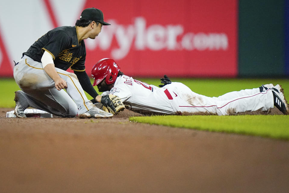 Cincinnati Reds' Delino DeShields (26) slides safely in second base before the tag from Pittsburgh Pirates' shortstop Hoy Park (68) during the seventh inning of a baseball game in Cincinnati, Tuesday, Sept 21, 2021. (AP Photo/Bryan Woolston)