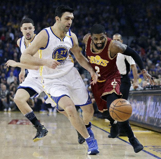 Cleveland Cavaliers' Kyrie Irving, right, and Golden State Warriors' Zaza Pachulia (27) chase a loose ball during the first half of an NBA basketball game Monday, Jan. 16, 2017, in Oakland, Calif. (AP Photo/Ben Margot)