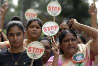 <p>Indian women’s cricket team captain Mithali Raj (L) along with the employees of South Central Railways take part in a rally on the eve of the United Nations (UN) International Day for the Elimination of Violence Against Women in Hyderabad on Nov. 24, 2017. (Photo: Noah Seelam/AFP/Getty Images) </p>