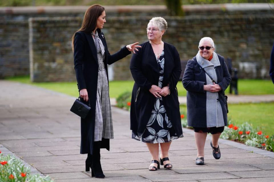 britains catherine, princess of wales l talks to guests during a visit with britains prince william, prince of wales not pictured to the aberfan memorial garden in aberfan, south wales on april 28, 2023, to pay their respects to those who lost their lives during the aberfan disaster on october 21, 1966 the garden sits on the site of the pantglas school which was tragically destroyed in a coal tip landslide on 21st october 1966 the incident led to the loss of 144 lives, including 116 children photo by ben birchall pool afp photo by ben birchallpoolafp via getty images