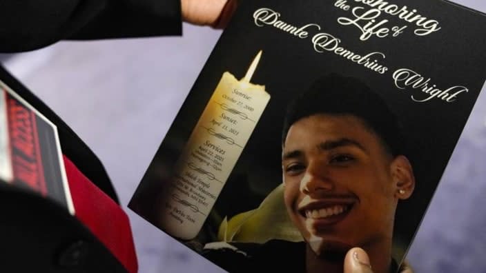 In this April 22, 2021 file photo, a mourner holds a program for the funeral services of Daunte Wright at Shiloh Temple International Ministries in Minneapolis, Minnesota. (Photo: John Minchillo/APbe, Pool, File)