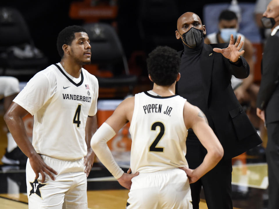 Vanderbilt head coach Jerry Stackhouse talks with guard's Jordan Wright (4) and Scotty Pippen Jr. (2) during the second half of an NCAA college basketball game against Arkansas, Saturday, Jan. 23, 2021, in Nashville, Tenn. Arkansas won 92-71. (AP Photo/Mark Zaleski)