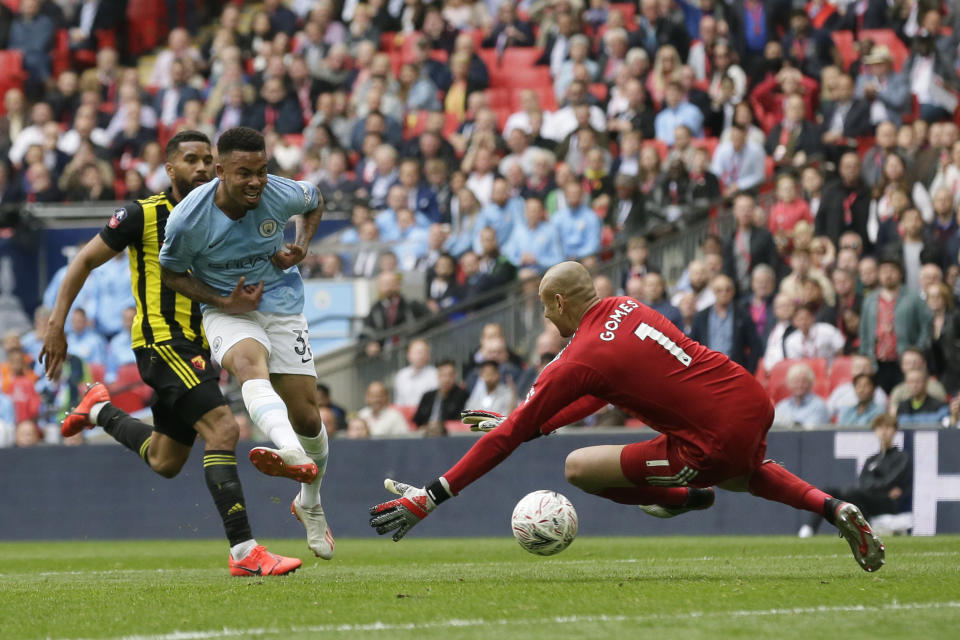 Manchester City's Gabriel Jesus, center, scores his side's fourth goal during the English FA Cup Final soccer match between Manchester City and Watford at Wembley stadium in London, Saturday, May 18, 2019. (AP Photo/Tim Ireland)