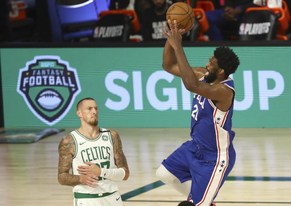 Philadelphia 76ers center Joel Embiid (21) shoots over Boston Celtics center Daniel Theis (27) during the third quarter of Game 4 of an NBA basketball first-round playoff series, Sunday, Aug. 23, 2020, in Lake Buena Vista, Fla. (Kim Klement/Pool Photo via AP)