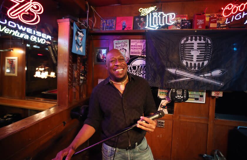 Tarzana, CA - October 25: Jerome Anderson, 51, running the open mic called Soapbox Sessions. Anderson supports the artists and cheering them and how he takes surprisingly delicate care with their dreams, talent or not at the Maui Sugar Mill Saloon in , Tarzana, CA on Tuesday, Oct. 25, 2022. (Allen J. Schaben / Los Angeles Times)