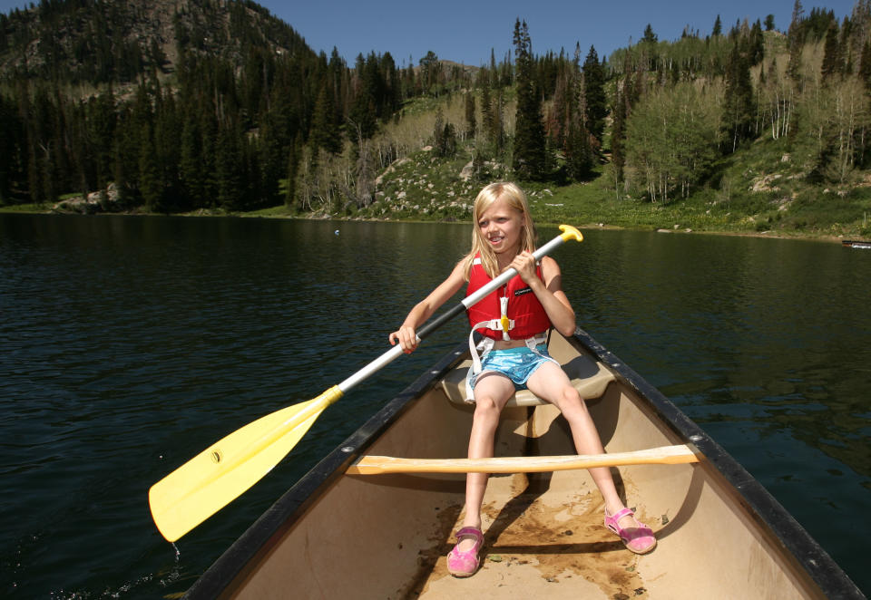 FILE - Girl Scout Zoe Kirtz, of Cedar City, Utah, paddles around Lake Brimhall in a canoe during summer camp at the Girl Scouts of Utah's Camp Cloud Rim above Park City, Utah, on June 26, 2007. Just a year after its centennial celebrations in 2012, the Girl Scouts of the USA's interconnected problems include declining membership and revenues, a dearth of volunteers, rifts between leadership and grass-roots members, a pension plan with a $347 million deficit, and an uproar over efforts by many local councils to sell venerable summer camps. As of June 2013, Camp Cloud Rim is still owned by the Girl Scouts. (AP Photo/Deseret Morning News, Jeffrey D. Allred)