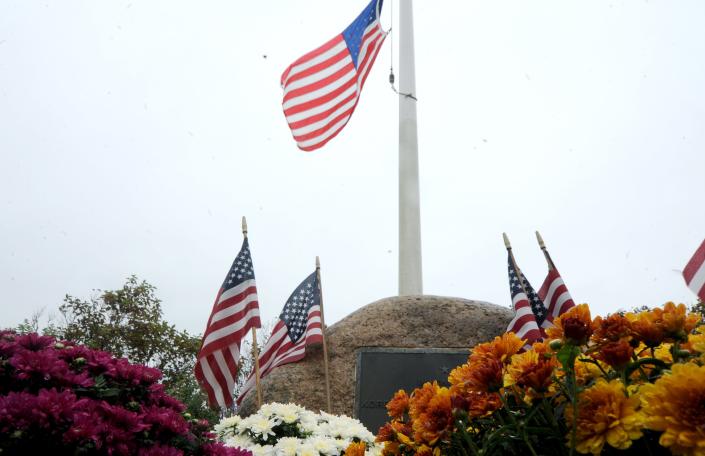 In this photo from October 2021, the flag flies at half staff at the Korean and Vietnam veterans memorial overlooking Oyster Pond in Chatham.  Merrily Cassidy/Cape Cod Times
