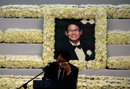 A man weeps in front of the picture of South Korean businessman Jee Ick-Joo, was allegedly killed by policemen inside the Camp Crame police camp, during a meomrial service in Quezon city Metro Manila, Philippines February 6, 2017. REUTERS/Erik De Castro