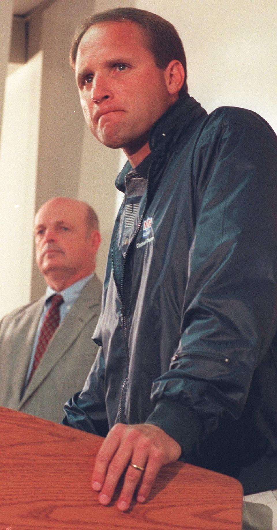 October 21, 1996. Cincinnati Bengals President and General Manager Mike Brown addresses the media during a press conference at Spinney Field Monday where Brown, left, announced that Head Coach Dave Shula, right, was stepping down as coach and is being replaced by offensive coordinator and former New York Jets head coach Bruce Coslet.