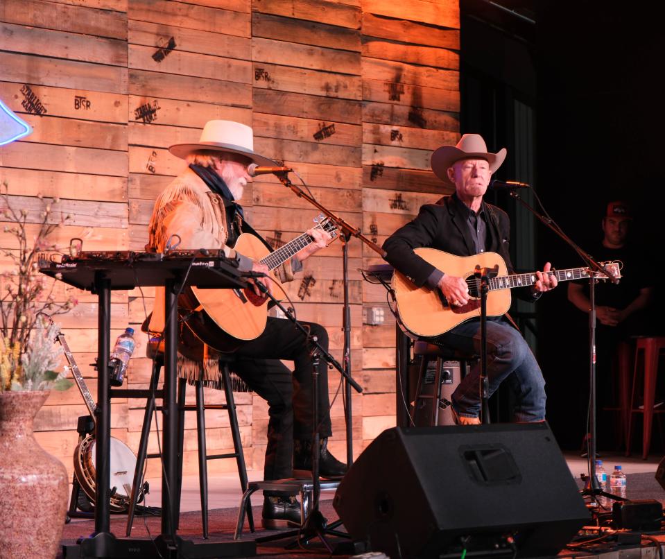 Lyle Lovett (right) sings with backing by Michael Martin Murphey Sunday evening at the Rangeland Fire Relief Benefit Concert at the Starlight Ranch in Amarillo.