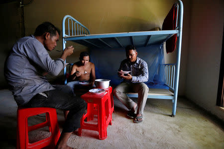 Workers have lunch inside an old casino room near Dara Sakor Hotel at Botum Sakor in Koh Kong province, Cambodia, September 27, 2017. REUTERS/Samrang Pring